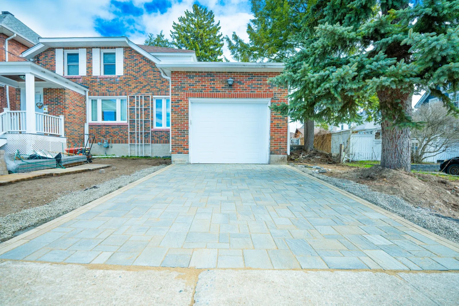 Finished interlock paver driveway leading to a garage, built by Bouwers Design Landscaping in North Bay