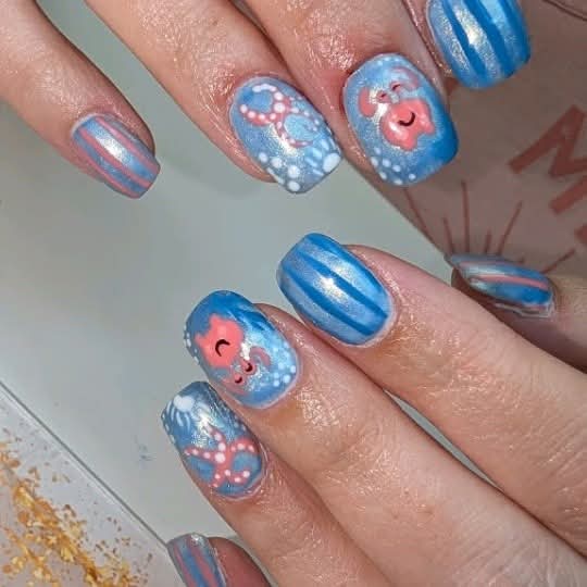 Blue and pink gel nails with hand painted crabs and starfish by Brea's Beauty Boutique