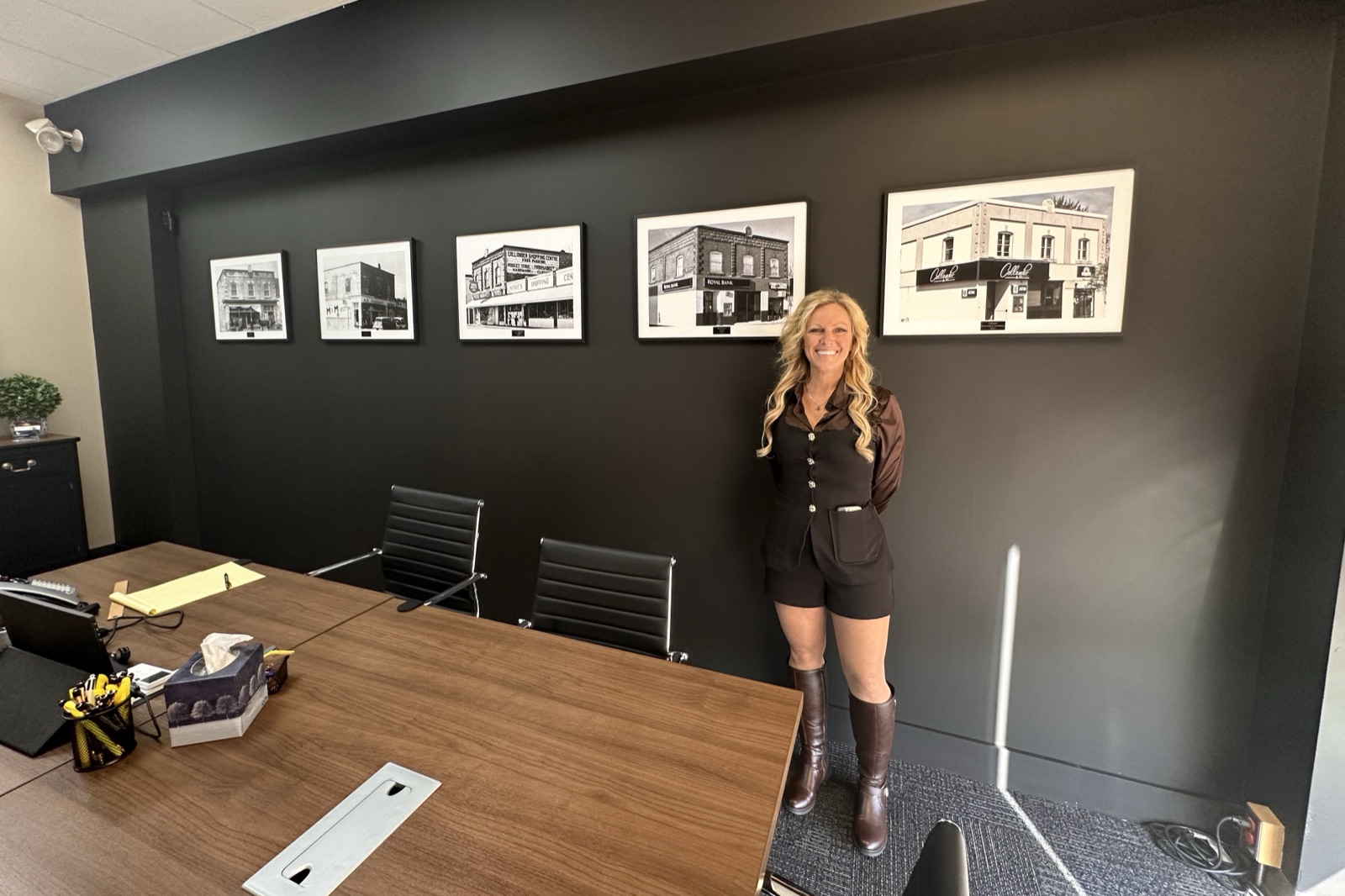 Kim McVeety in the Callander Accounting & Consultancy boardroom under framed photos of the building's history