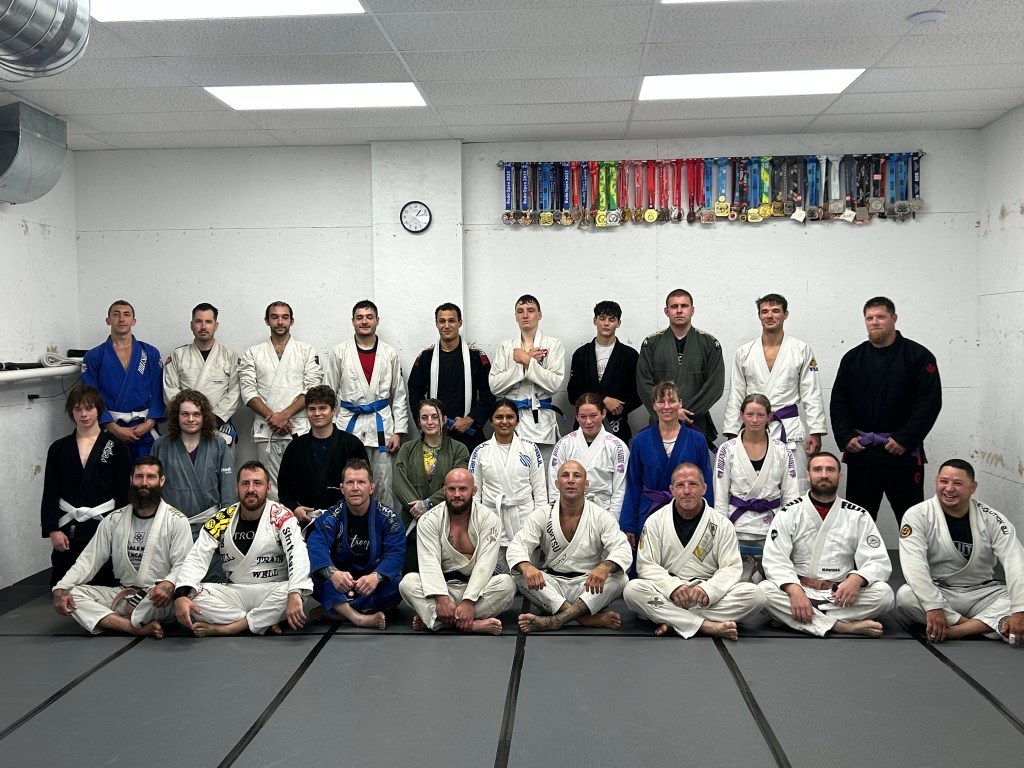 Brazilian Jiu Jitsu students and coaches at a grading at Coalition Martial Arts