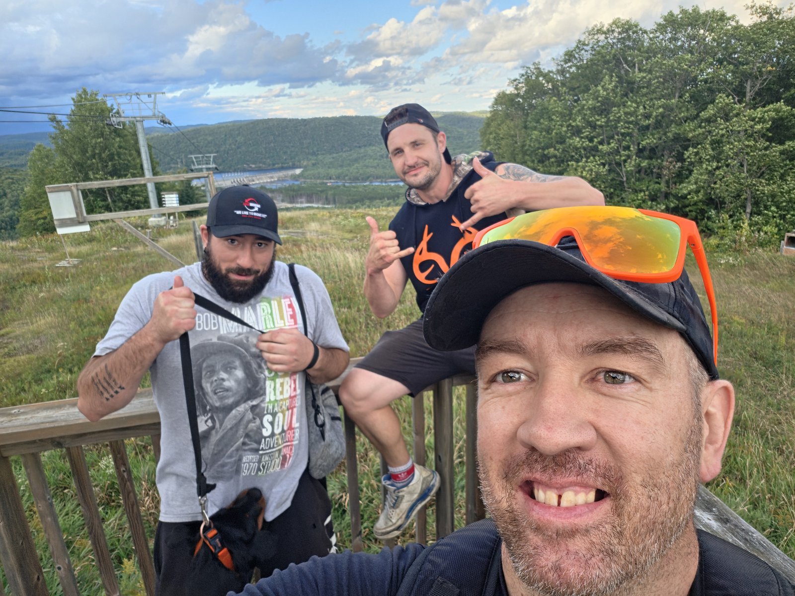 Blake Tomlinson with two friends at the top of a hike