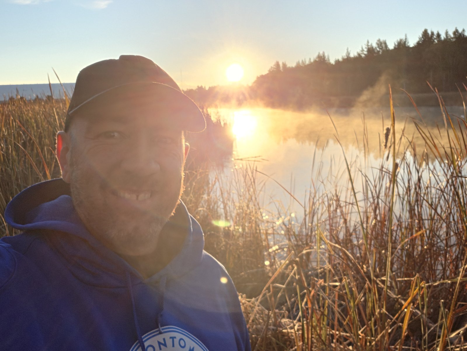 Blake Tomlinson at sunrise beside the water in North Bay