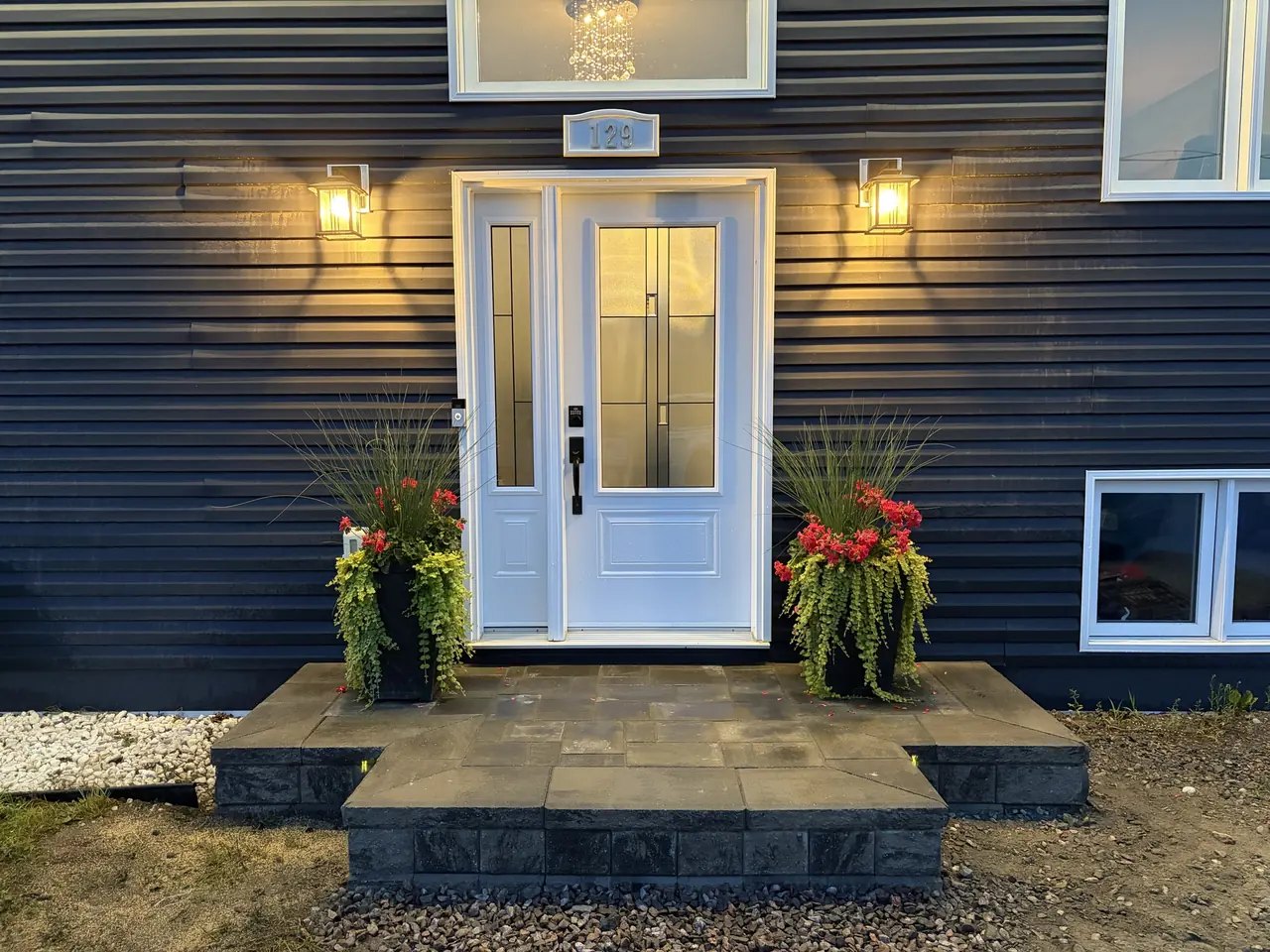 Paver front entrance with stone steps and lantern lighting built by Edwards Landscape and Construction in North Bay