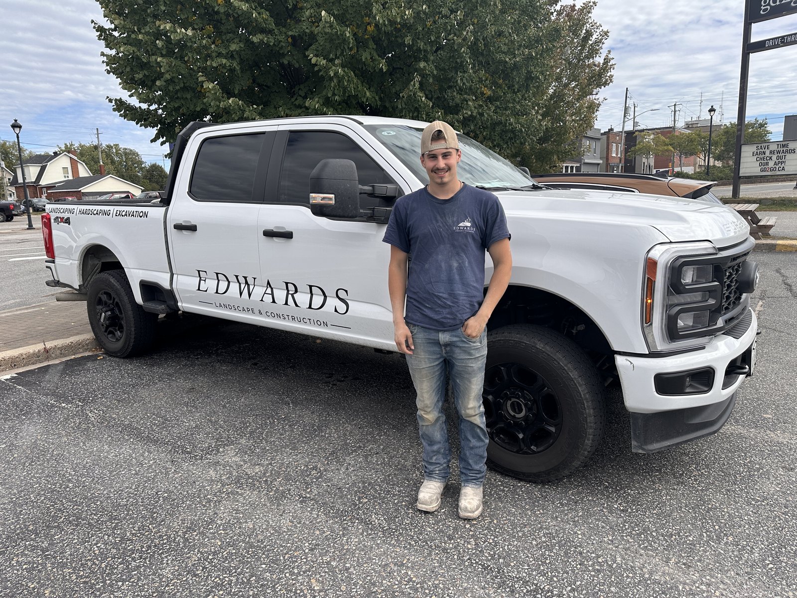 Kayden Edwards of Edwards Landscape and Construction standing beside his company truck in North Bay