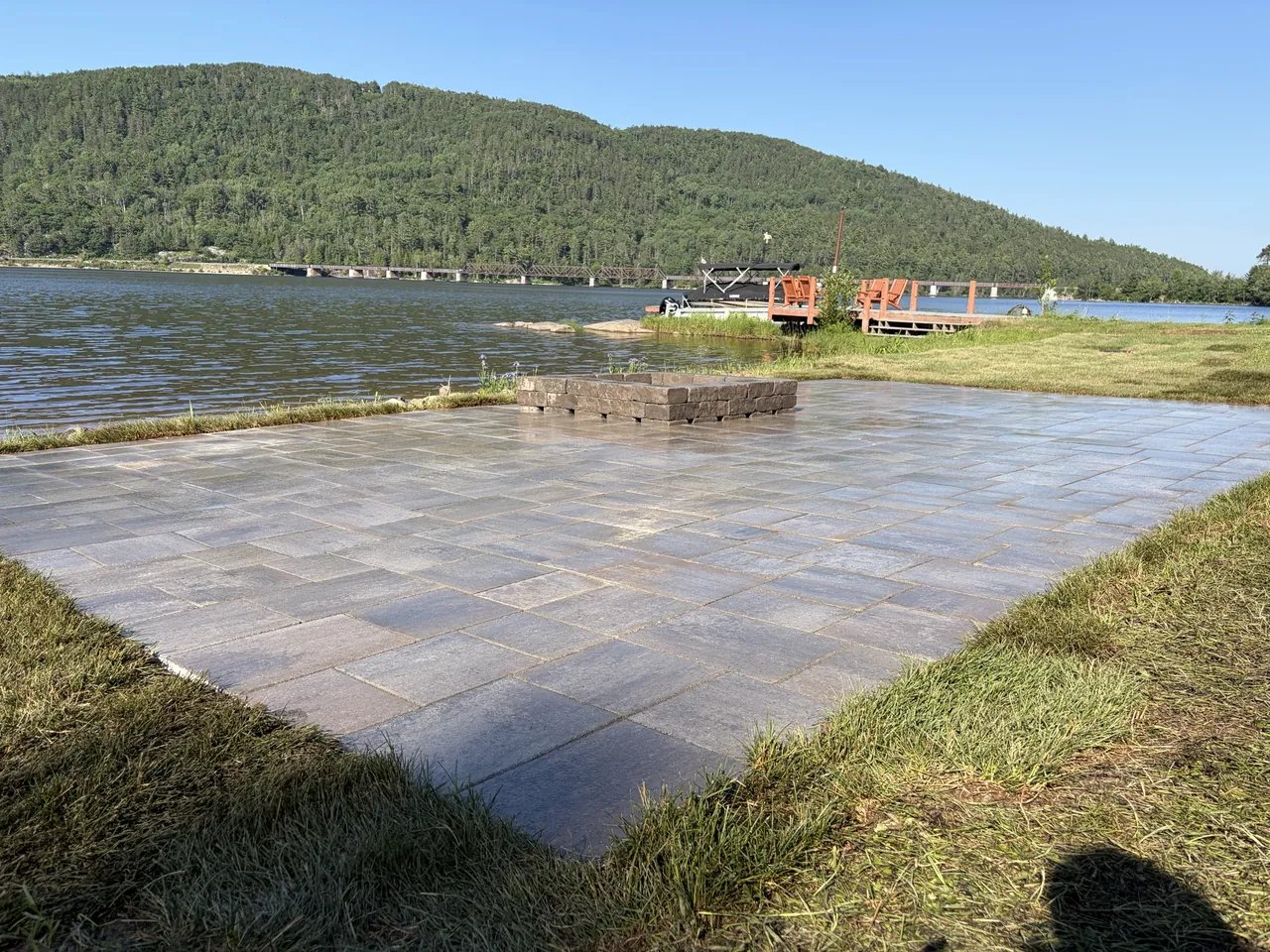 Large waterfront interlock paver patio built by Edwards Landscape and Construction near North Bay