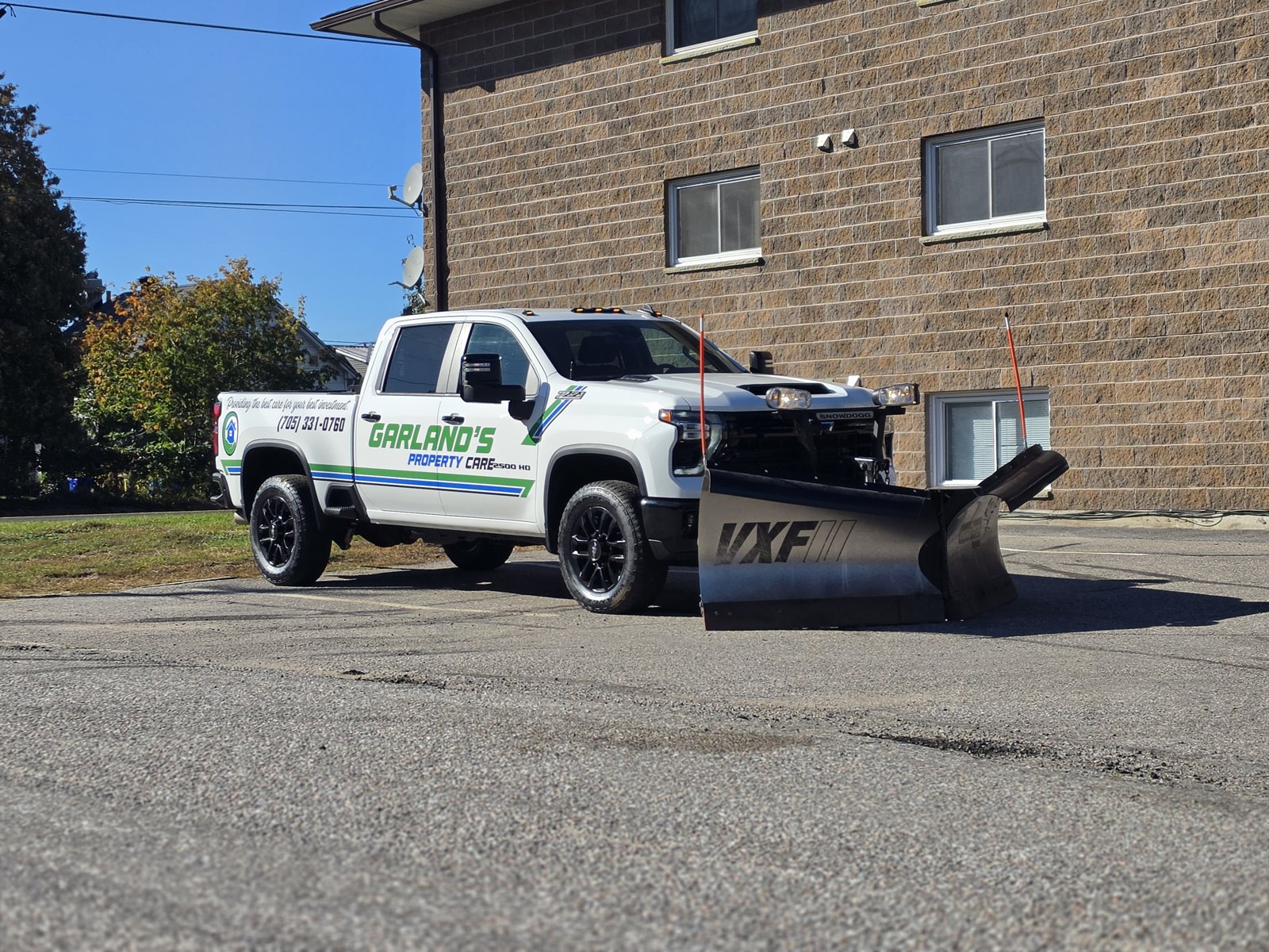 Garland's Property Care pickup truck with a VXF snow plow mounted, parked in North Bay