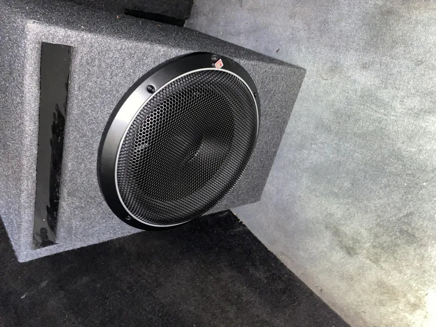 A custom carpeted subwoofer enclosure with a Rockford Fosgate subwoofer