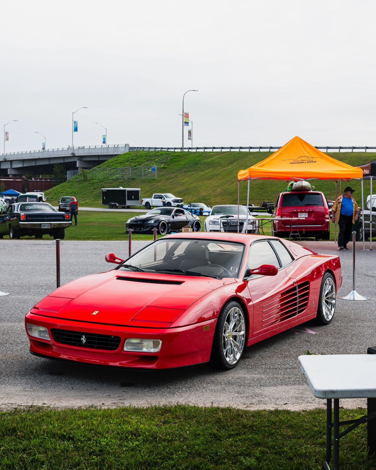 A red Ferrari Testarossa detailed by Northern Detail & Polish on display at a North Bay car show