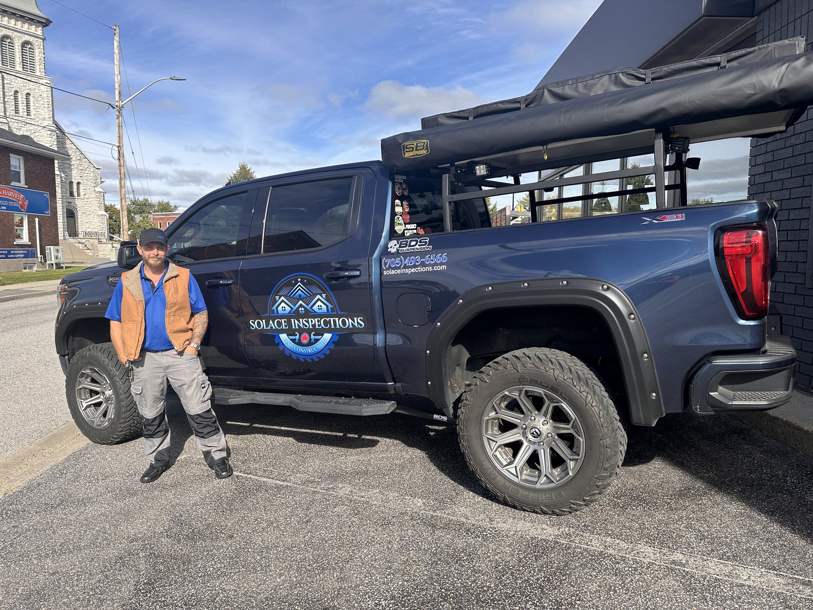 Chris Marcoux standing beside the Solace Inspections & Construction truck in Powassan